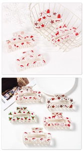 Detailed close-up of cute Christmas themed hair clips with colorful cartoon patterns