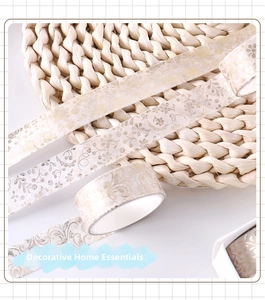 Detail of vintage champagne gold foil washi tape with elegant floral vine patterns