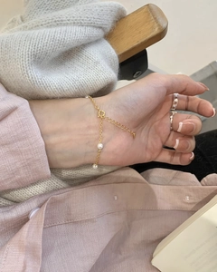 Detail of s925 silver pearl bead bracelet with adjustable lobster clasp on a woman's wrist