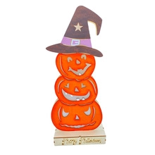 Detail of stacked wooden Halloween pumpkins with a wizard hat and Happy Halloween base