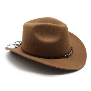 Detailed view of brown felt cowboy hat with beaded woven band and curved wide brim