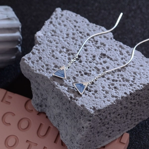 Minimalist Mount Fuji ear wires with blue enamel drip pendant on grey stone display