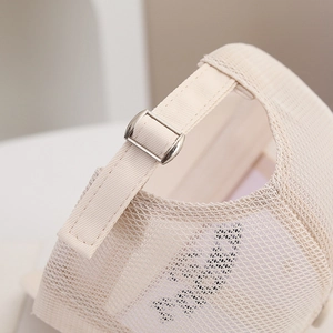 Detail of breathable mesh fabric and adjustable silver metal buckle on kids baseball cap