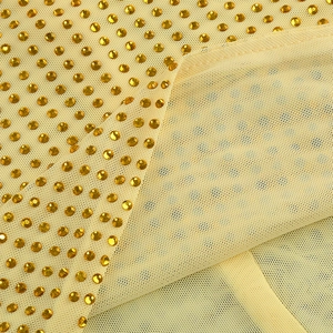 Gros plan du tissu en maille champagne orné de strass brillants scintillants