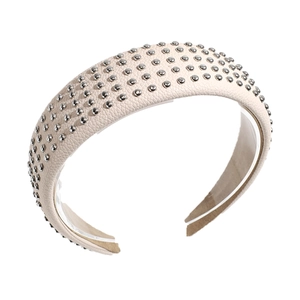 Minimalist beige leather headband with silver metal studs on a white background