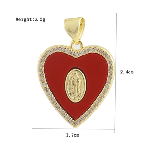Detailed view of a gold heart pendant with red enamel, crystal border and religious relief