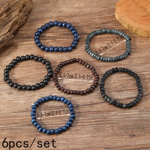 Detail of 6pcs multilayer wood bead bracelet set with textured grains on a rustic background