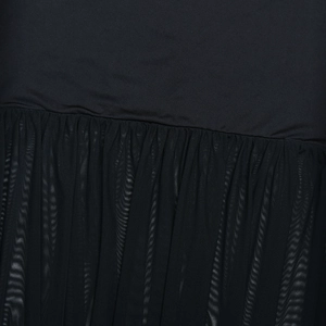 Detail shot of black fabric stitching with mesh textures and fishtail dress craftsmanship