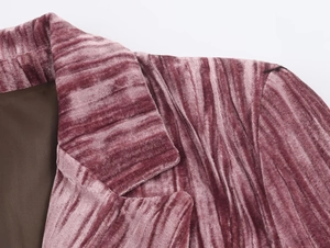Detailed close-up of pleated velvet blazer lapel and shoulder with premium brown lining