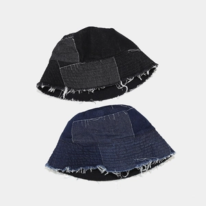 Detail of distressed raw edges and patchwork denim on vintage style fisherman hats