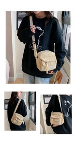 Detail of light beige corduroy crossbody bag featuring a textured flap and woven zipper pull