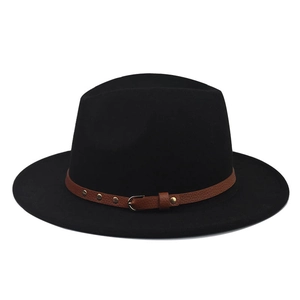 Detail of black wool fedora featuring a brown leather band with gold studs and buckle