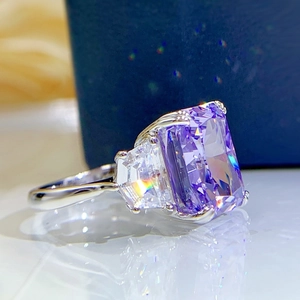 Macro shot of rectangular purple gemstone ring with trapezoidal side stones in silver