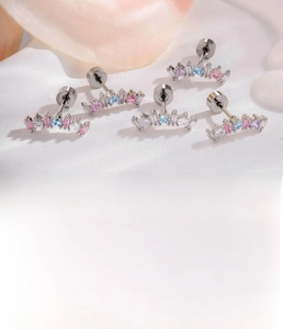 Macro detail of silver cartilage stud featuring colorful zircons and threaded disk back