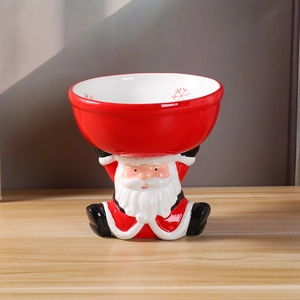 Creative Santa Claus ceramic raised cat bowl with red snowflake pattern on wooden table