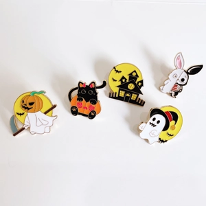 Set of five cartoon Halloween enamel pins with ghosts, pumpkin cats, and bats on white background
