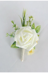 Detail of white rose wedding boutonniere with silk wrapped stem and green leaf accents