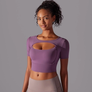 Detail of burgundy mesh crop top featuring oval cutout and high-stretch sports fabric
