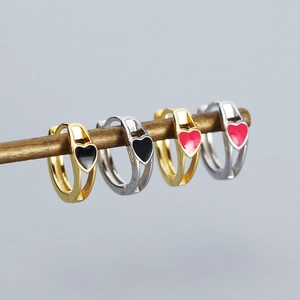 Detailed view of S925 silver hoop earrings with red and black heart enamel charms