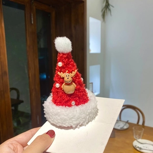 Christmas hair clip featuring a red plush Santa hat with reindeer doll and white pearls