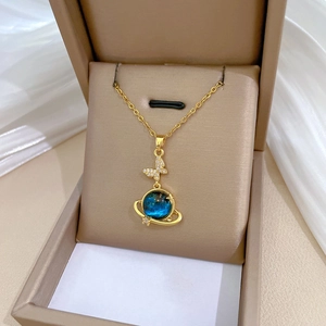 Titanium butterfly planet necklace with blue star elements and sparkling crystals in a box