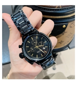Close-up of black TICTOC chronograph watch with steel strap and protective film