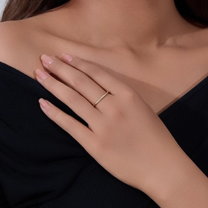 Minimalist 14K gold plated sterling silver ring on model's index finger closeup