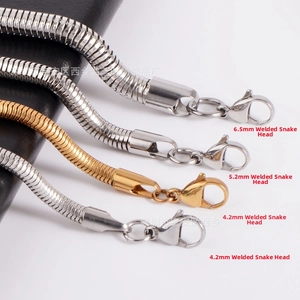Detail of stainless steel snake chain necklaces in silver and gold with lobster clasps