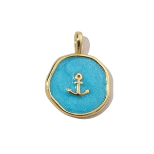 Macro detail of nautical anchor charm with blue glitter enamel and golden finish