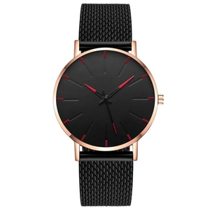 Close-up of black quartz watch with rose gold case and black mesh steel strap