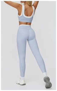 Detail view of the back of light blue yoga set featuring white contrast trim and racerback bra