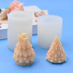 Christmas tree and geometric cone silicone molds for DIY candle making on blue background