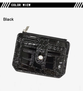 Detail of black crocodile texture card holder with silver zipper and snap closure