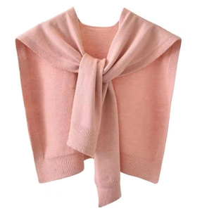 Detail of pink knitted shawl wrap showing fine texture and ribbed edge craftsmanship