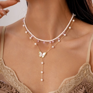 Close-up of double-layer butterfly pearl necklace with pink water drop pendant on neck