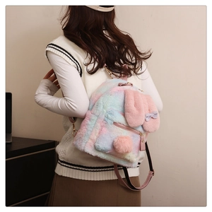 Detail of colorful tie-dye faux fur rabbit backpack with plush ears and a bow