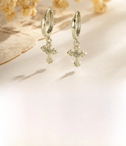 Detail shot of vintage coffee gold cross earrings made of copper and zircon stone
