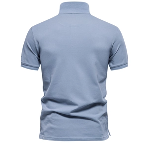 Macro detail of the breathable pique fabric and collar stitching on a blue polo shirt