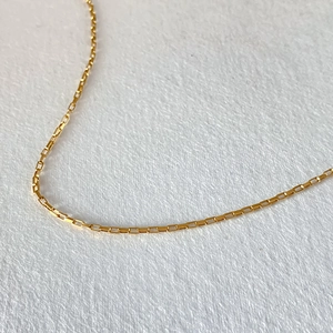 Close-up of 14K gold plated stainless steel box chain necklace with fine square links