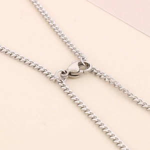 Macro close-up of the stainless steel lobster clasp and Cuban chain of the bracelet