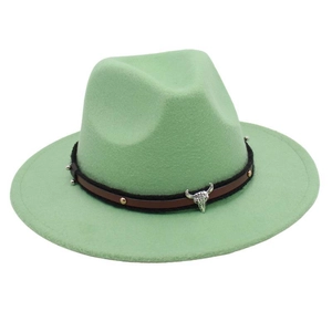 Detailed close-up of light green felt fedora hat with silver bull head and rivet band