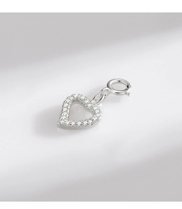 Macro shot of silver heart pendant with pavé set cubic zirconia and spring clasp closure