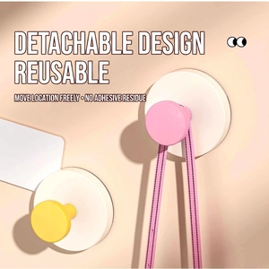 Powerful suction cup wall hooks in pink and yellow with a reusable detachable design