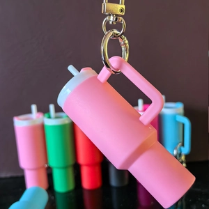 Detailed view of mini pink tumbler keychain with metal ring for lip balm holder use
