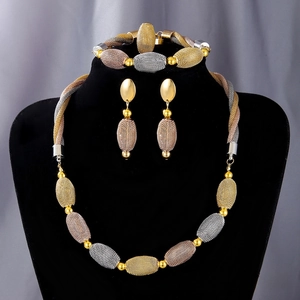 Detailed view of tricolor woven mesh bead necklace set displayed on a black bust mannequin