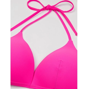 Close-up of fuchsia halter bikini top showing fine stitching and smooth fabric texture