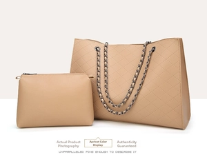 Detail view of apricot quilted tote and matching clutch with chain shoulder strap