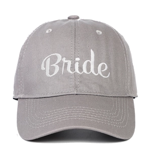Detailed view of gray cotton baseball cap featuring white Bride script embroidery