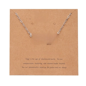 Silver Virgo zodiac necklace with gothic font pendant on a descriptive Kraft paper card