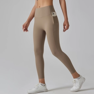 Close-up of high-waisted yoga pants with side pocket holding a smartphone in khaki